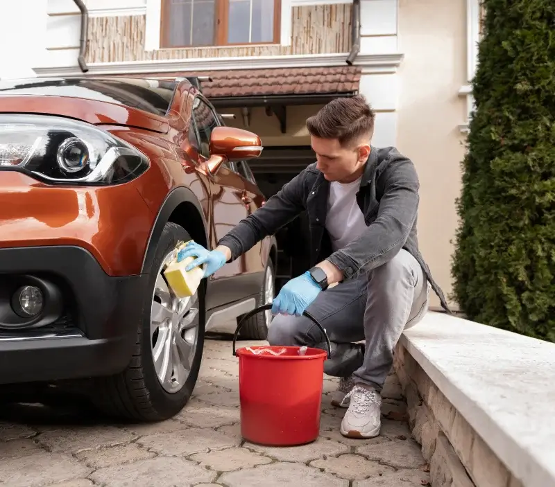 Lavage auto à domicile Naucelles : professionnel intervenant sur un véhicule